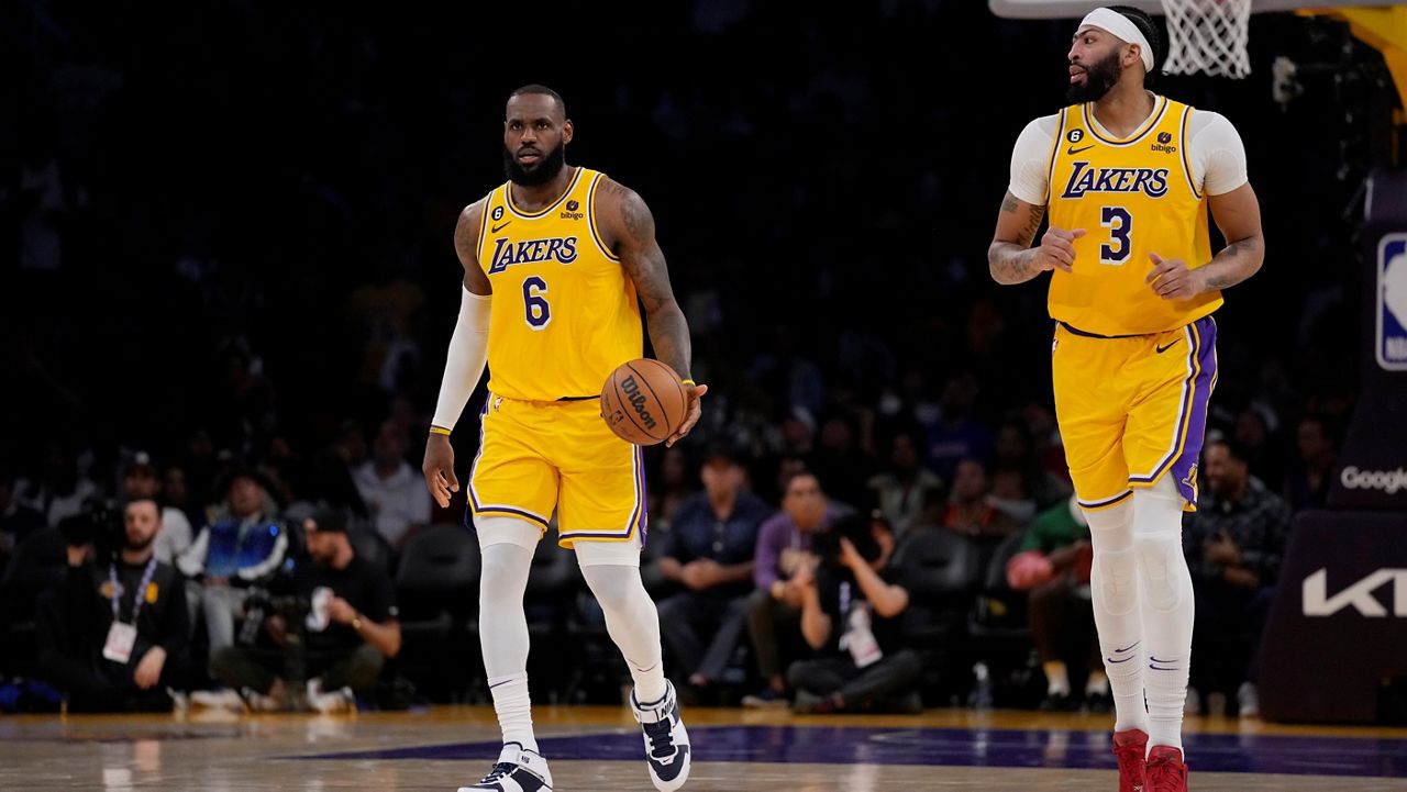 Los Angeles Lakers forward LeBron James (6) dribbles behind forward Anthony Davis (3) during the second half in Game 6 of an NBA basketball Western Conference semifinal series against the Golden State Warriors Friday, May 12, 2023, in Los Angeles. (AP Photo/Ashley Landis)