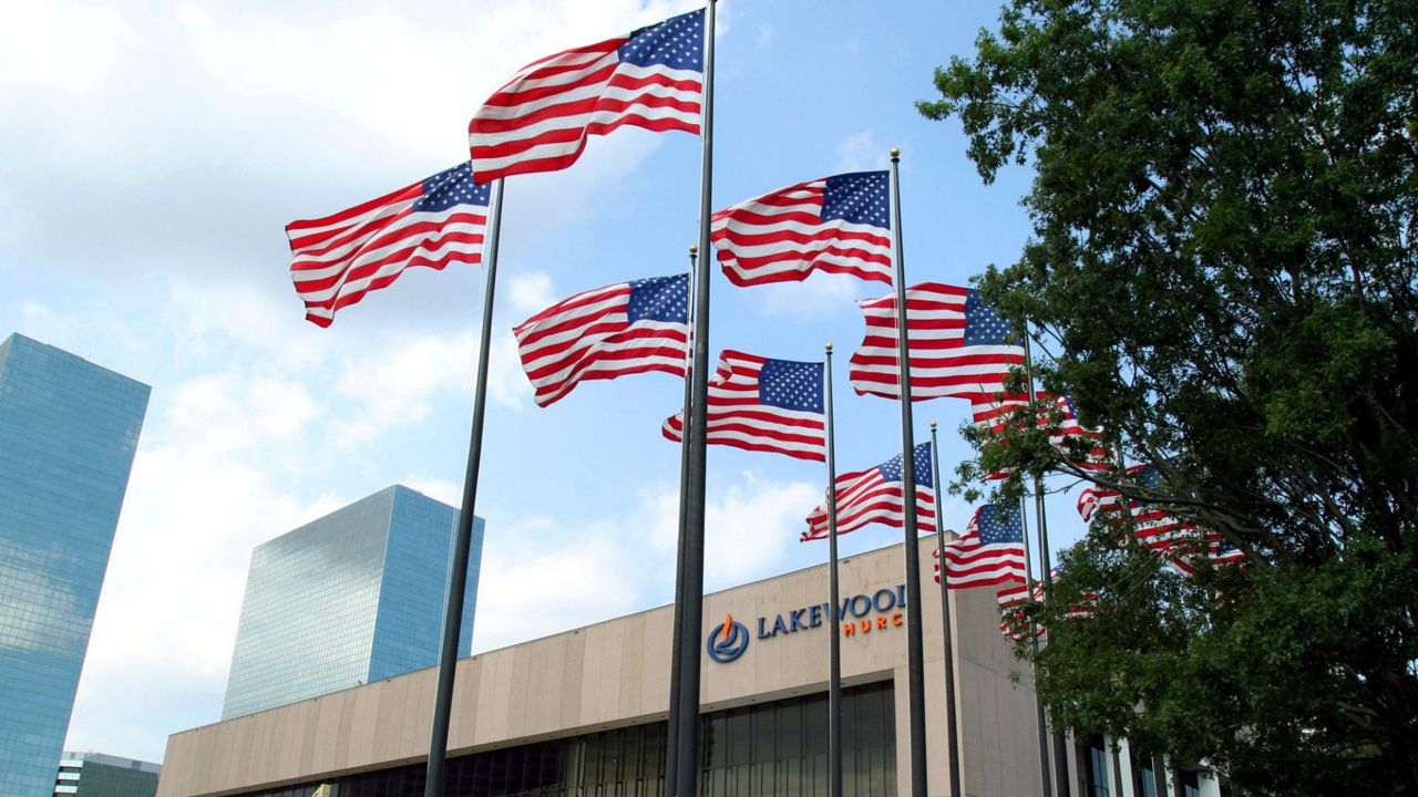 Flags fly in front of the Lakewood Church in Houston, June 28, 2005. (AP Photo/Pat Sullivan, File) 