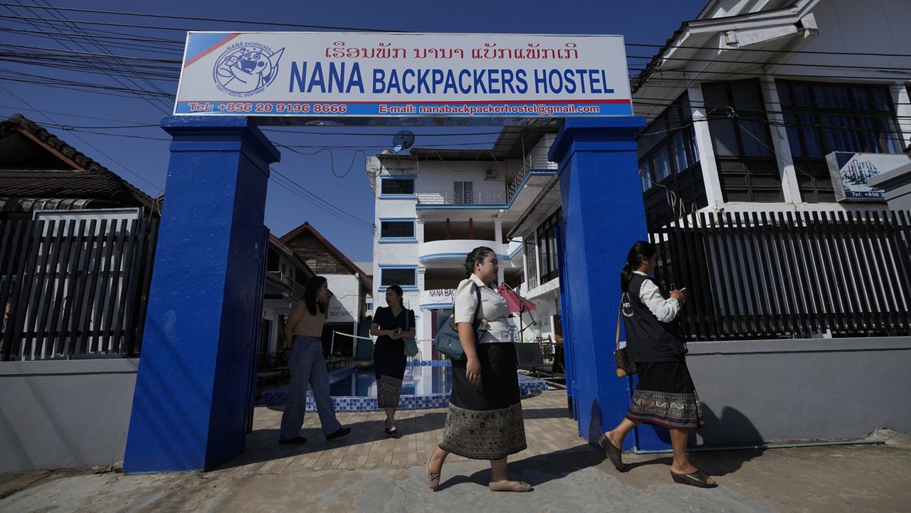 Health officials come out of Nana Backpackers hostel after checking documents in Vang Vieng, Laos, Friday, Nov. 22, 2024. (AP Photo/Anupam Nath)