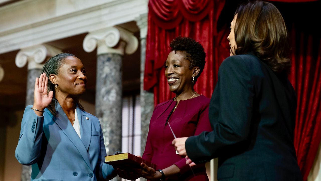 Vice President Kamala Harris, right, swears in Laphonza Butler, D-Calif., left, to the Senate to succeed the late Sen. Dianne Feinstein during a re-enactment of the swearing-in ceremony on Tuesday, Oct. 3, 2023, on Capitol Hill in Washington. Butler's wife, Neneki Lee, center, holds the Bible. (AP Photo/Stephanie Scarbrough)