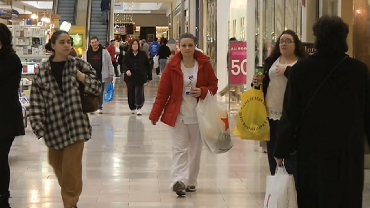 people walking through shopping mall during holidays