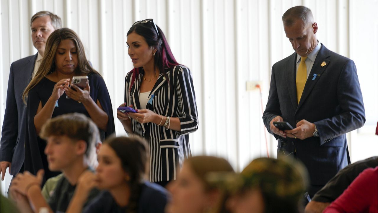 Lynne Patton, Laura Loomer and Corey Lewandowski watch as Republican presidential nominee former President Donald Trump visits the Shanksville Volunteer Fire Company in Shanksville, Pa., Wednesday, Sept. 11, 2024. (AP Photo/Matt Rourke)