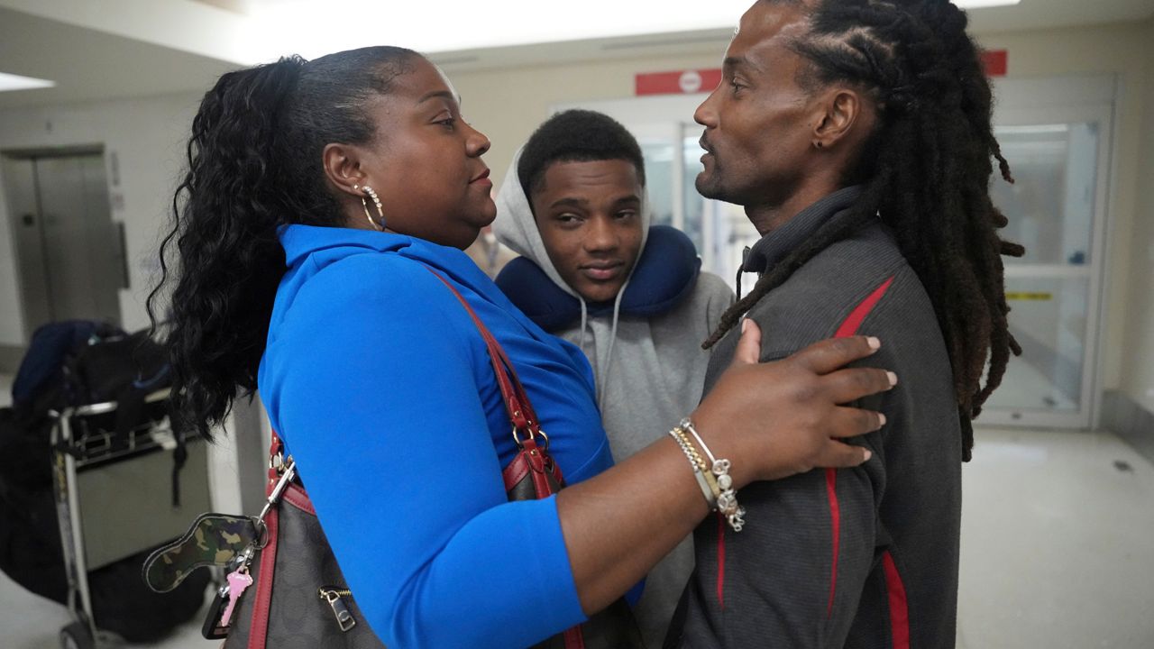 Valerie Laveus greets her brother Reginald Malherbe Daniel and her nephew Tristan-Ryan Malherbe Daniel as they arrive for the first time to the United States from Haiti at Fort Lauderdale-Hollywood International Airport, in Fort Lauderdale, Fla., Wednesday, Aug. 9, 2023. (AP Photo/Jim Rassol)