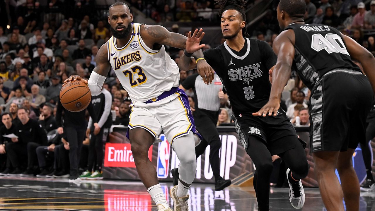 Los Angeles Lakers' LeBron James (23) drives against San Antonio Spurs' Stephon Castle (5) during the first half of an Emirates NBA Cup basketball game, Friday, Nov. 15, 2024, in San Antonio. (AP Photo/Darren Abate)