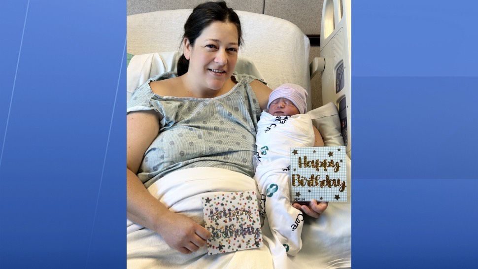 Lisa Barkow holds her baby Cole Barkow and birthday cards. 