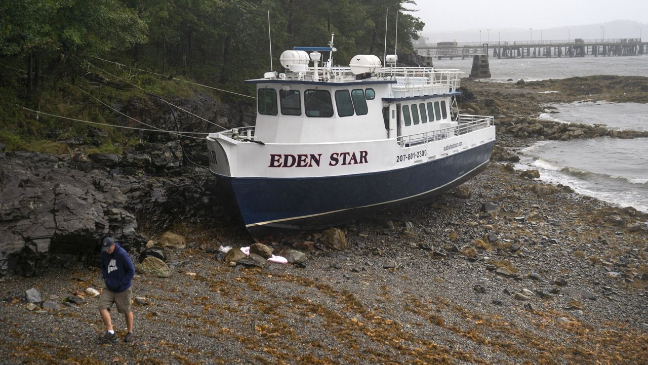 The Eden Star, a 70-foot tour boat, is secured to the shore after breaking free of its mooring during storm Lee, Saturday, Sept. 16, 2023, in Bar Harbor, Maine, (AP Photo/Robert F. Bukaty)