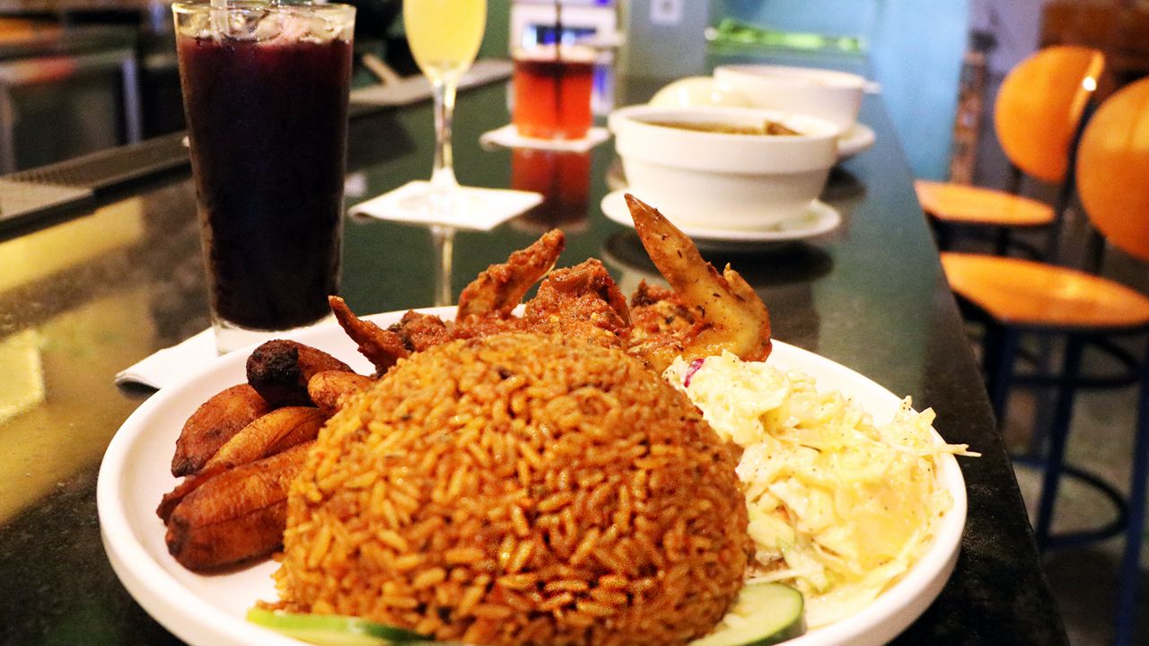 Pictured is jollof with chicken and coleslaw alongside a hibiscus cocktail called Zobo. (Spectrum News/Elizabeth Barmeier)