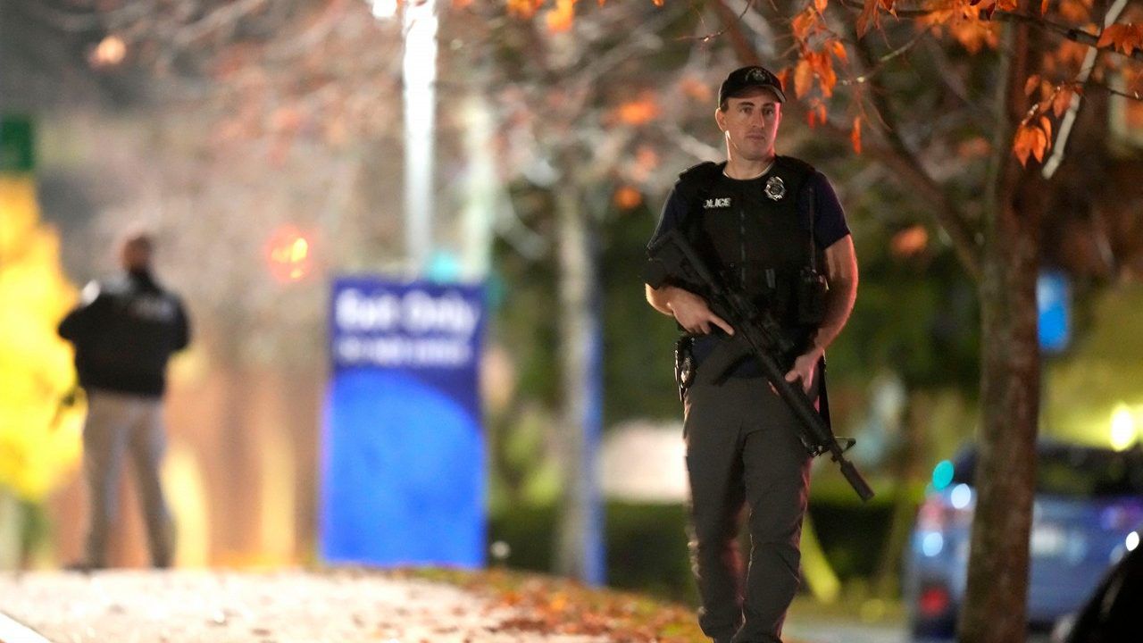 Law enforcement officers carry rifles outside Central Maine Medical Center during an active shooter situation, in Lewiston, Maine, Wednesday, Oct. 25, 2023. (AP Photo/Steven Senne)