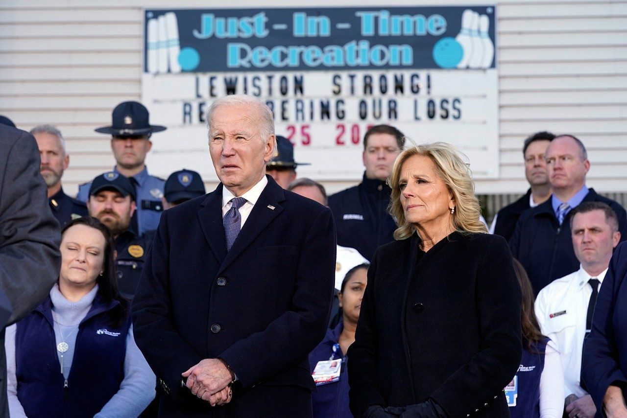 FILE - President Joe Biden, with first lady Jill Biden, listens outside of Just-In-Time Recreation before he speaks Friday, Nov. 3, in Lewiston, about the mass shooting on Oct. 25. The deputy director of the new gun violence prevention office at the White House spent the last week in Lewiston, Maine helping the community recover from a mass shooting. (AP Photo/Evan Vucci, File)