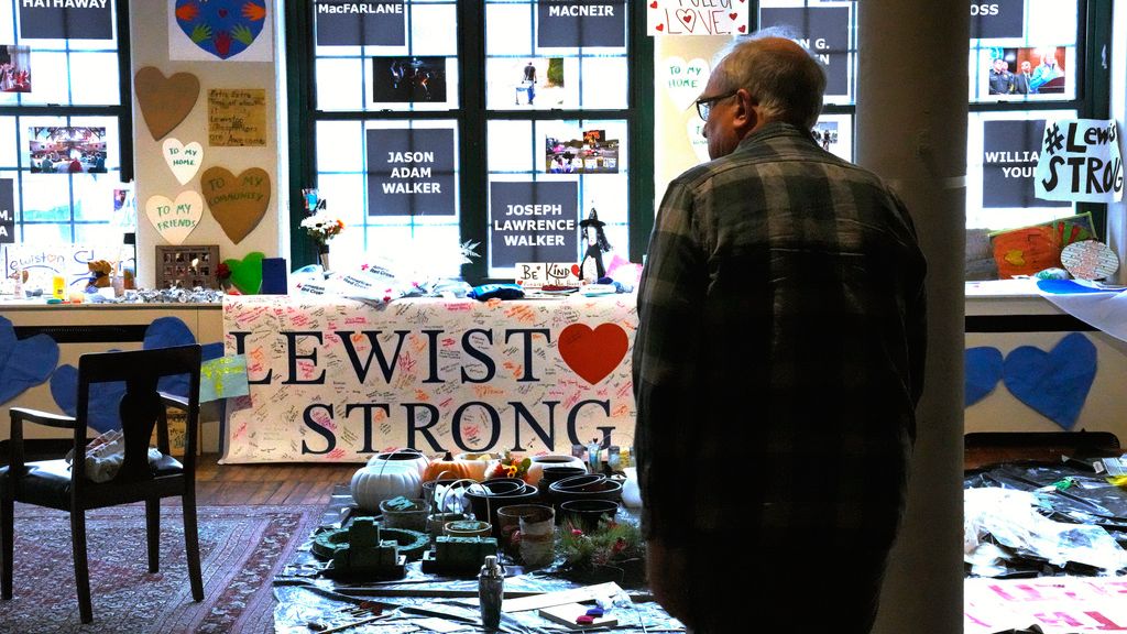 Volunteer Rich Beard looks over archived items, many left at memorials outside Lewiston shooting sites, at the Maine Museum of Innovation, Learning and Labor, Wednesday, Dec. 27, 2023, in Lewiston, Maine. (AP Photo/Charles Krupa)