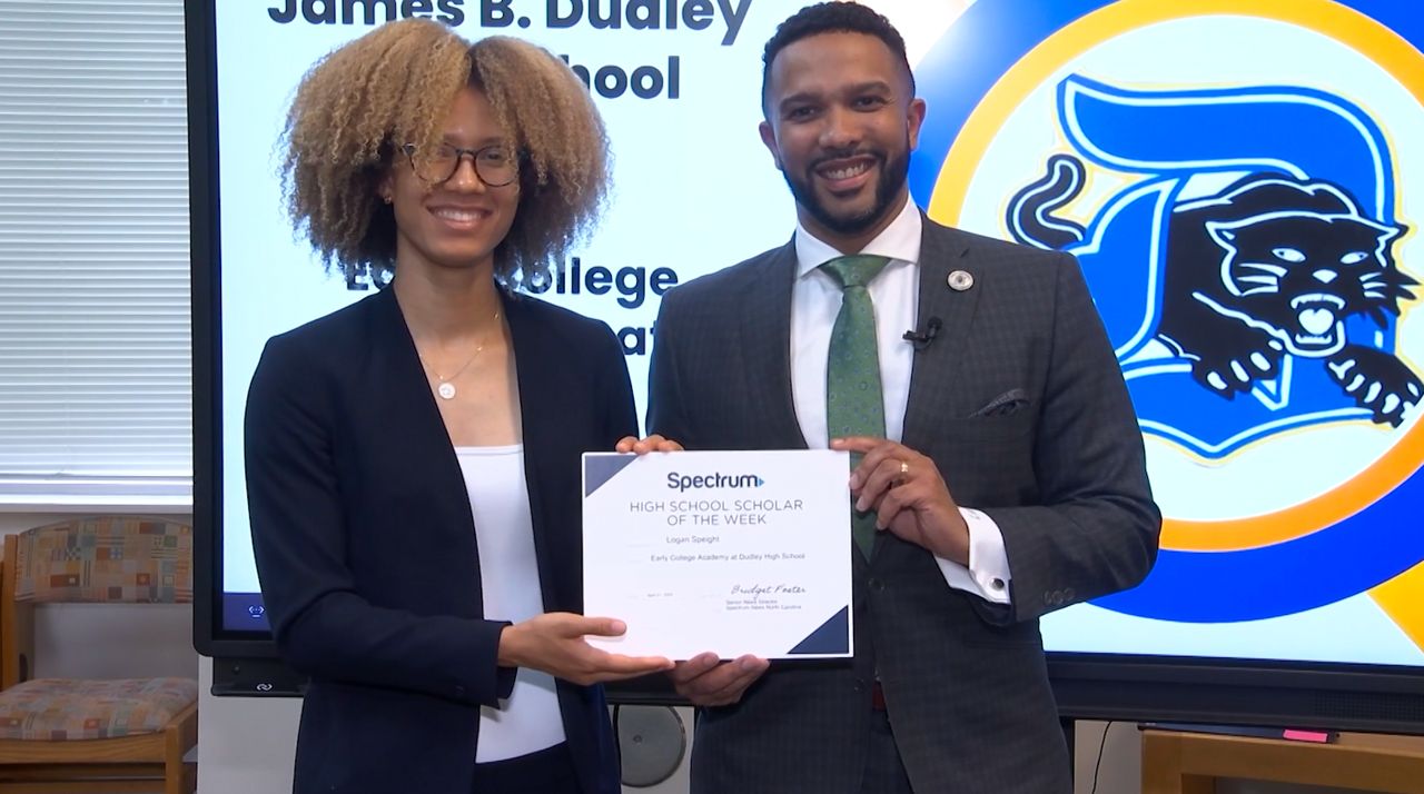 Logan Speight with Greensboro County Commissioner Frankie T. Jones accepting $1,000 Spectrum Scholarship (Spectrum News 1/Zyneria Byrd)