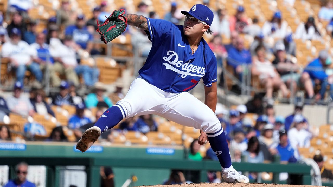 Los Angeles Dodgers starting pitcher Julio Urias throws a pitch against the Cincinnati Reds during the second inning of a spring training baseball game Tuesday, Feb. 28, 2023, in Phoenix. (AP Photo/Ross D. Franklin)