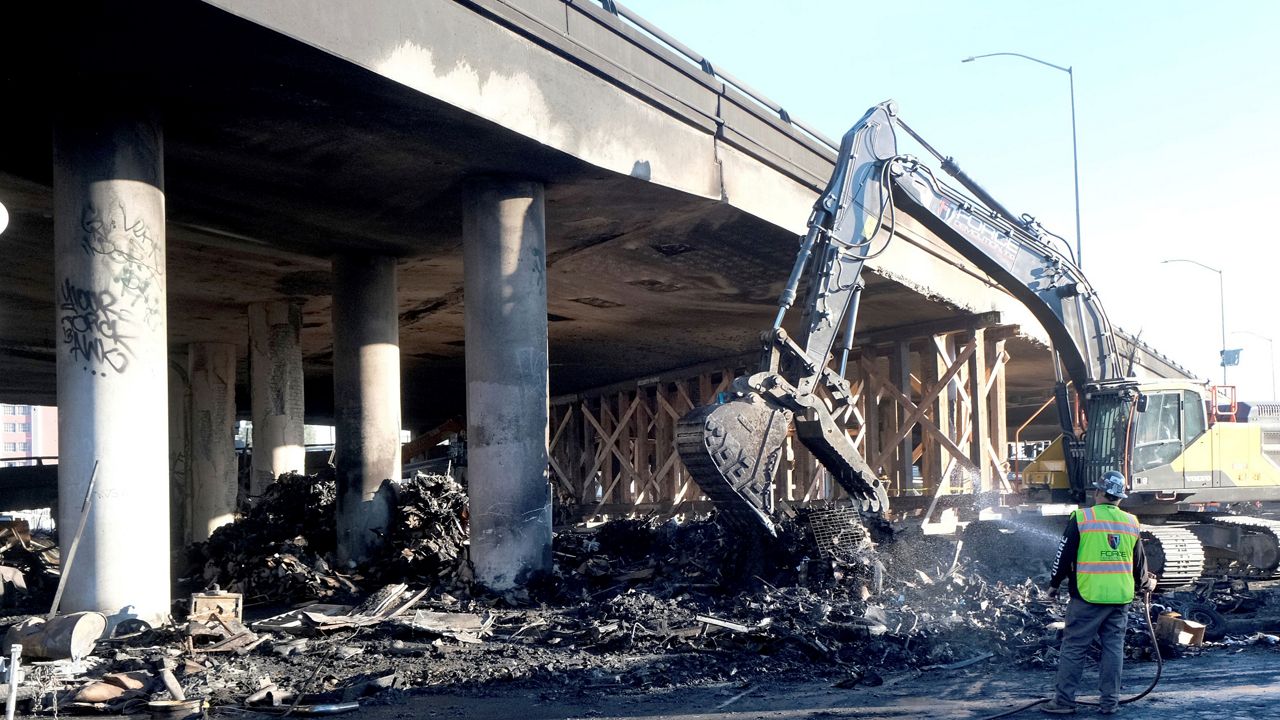 Crews continue to clear debris and shore up a stretch of Interstate 10, Tuesday morning Nov. 14, 2023, in Los Angeles. (Dean Musgrove/The Orange County Register via AP)