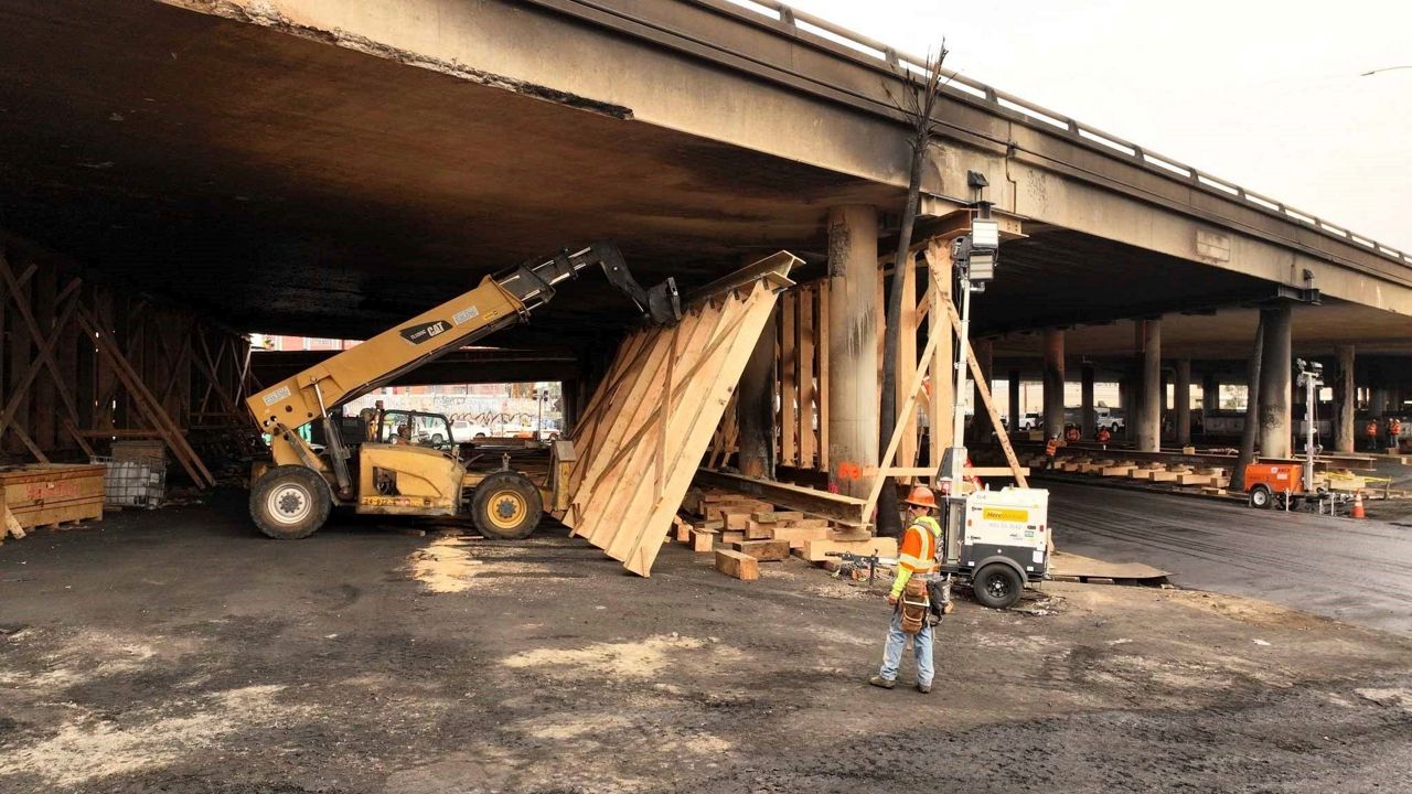 This photo provided by the California Department of Transportation shows a work crew shoring up a section under Interstate 10 that was severely damaged in a fire in an industrial zone near downtown Los Angeles on Wednesday, Nov. 15, 2023. The area under the freeway that burned last weekend, damaging a section of a key thoroughfare in the car-dependent city, was stacked with flammable materials on lots leased by the state through a little-known program that now is under scrutiny. (Jack Snyder/Caltrans District 7 via AP)