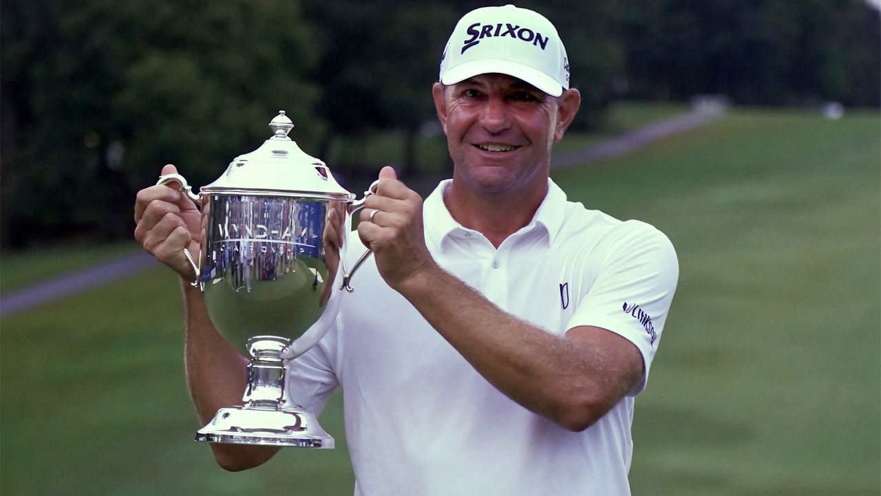Lucas Glover poses with the trophy after winning the Wyndham Championship golf tournament in Greensboro, N.C., Sunday, Aug. 6, 2023. (AP Photo/Chuck Burton)