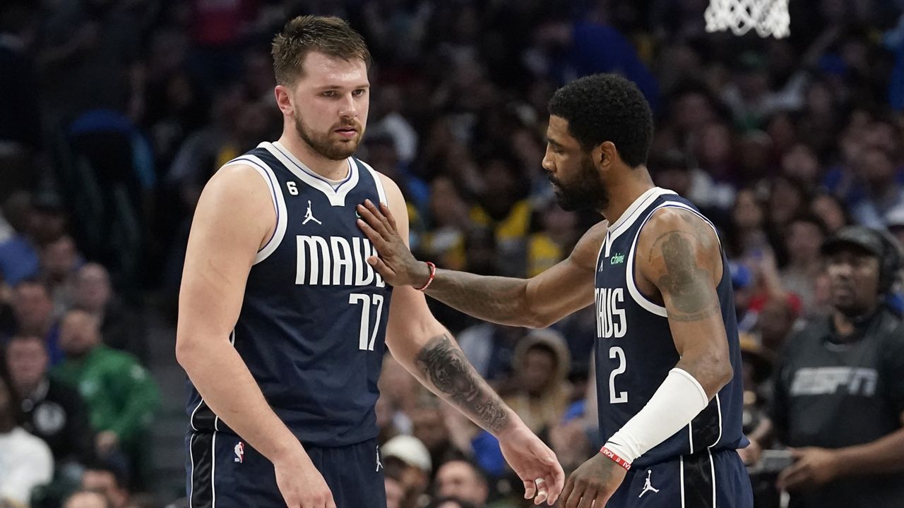 Dallas Mavericks guard Luka Doncic (77) gets a pat from teammate guard Kyrie Irving (2) during the second half of an NBA basketball game against the Los Angeles Lakers in Dallas, Sunday, Feb. 26, 2023. (AP Photo/LM Otero)