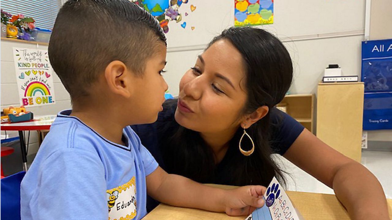 Lupita Cabrera gives her son Edwardo a kiss on his first day of Pre-K at Menchaca Early Childhood Center. (Spectrum News 1)