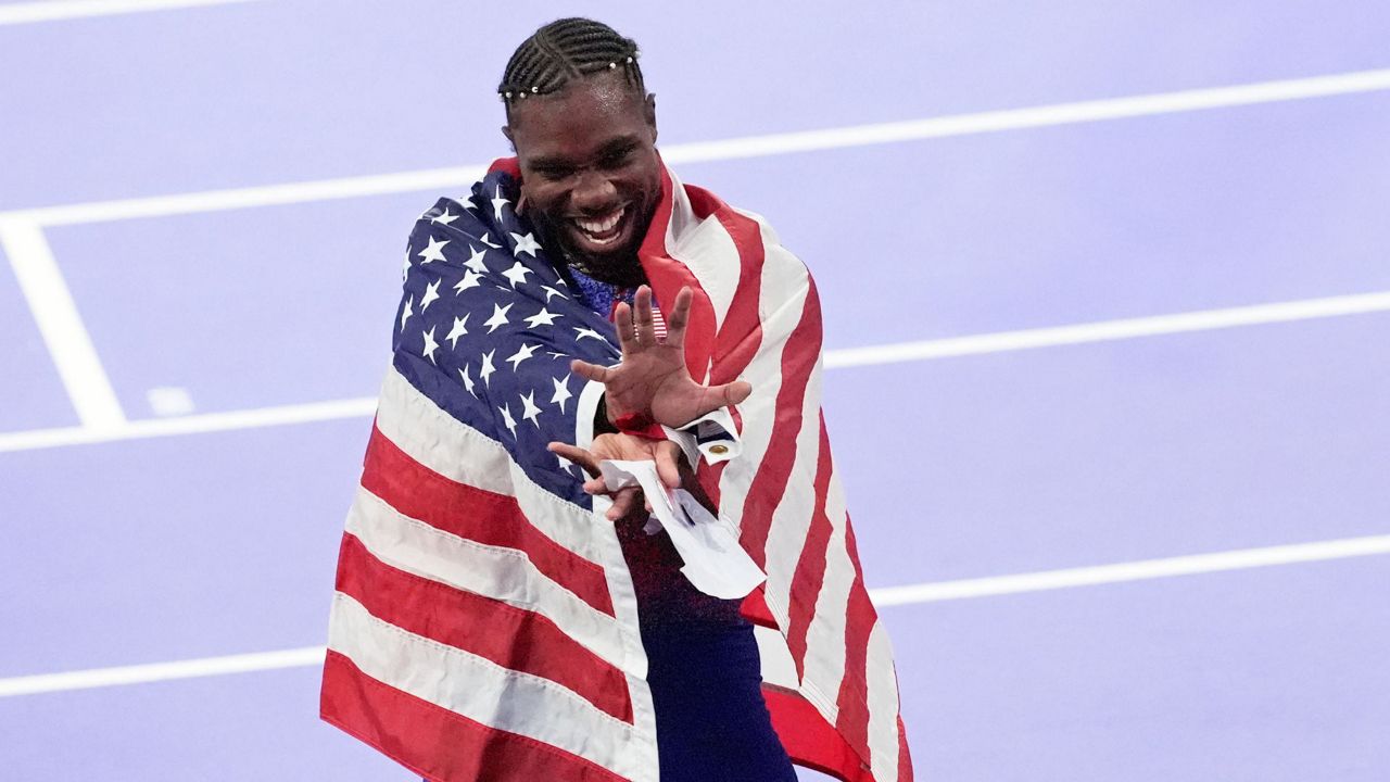 Noah Lyles, of the United States, celebrates after winning the gold medal in in the men's 100 meters final at the 2024 Summer Olympics, Sunday, Aug. 4, 2024, in Saint-Denis, France. (AP Photo/Martin Meissner)