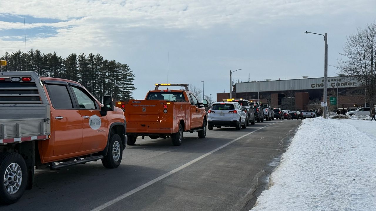 A procession of work vehicles moves towards the Augusta Civic Center. (Spectrum News/David Ledford)