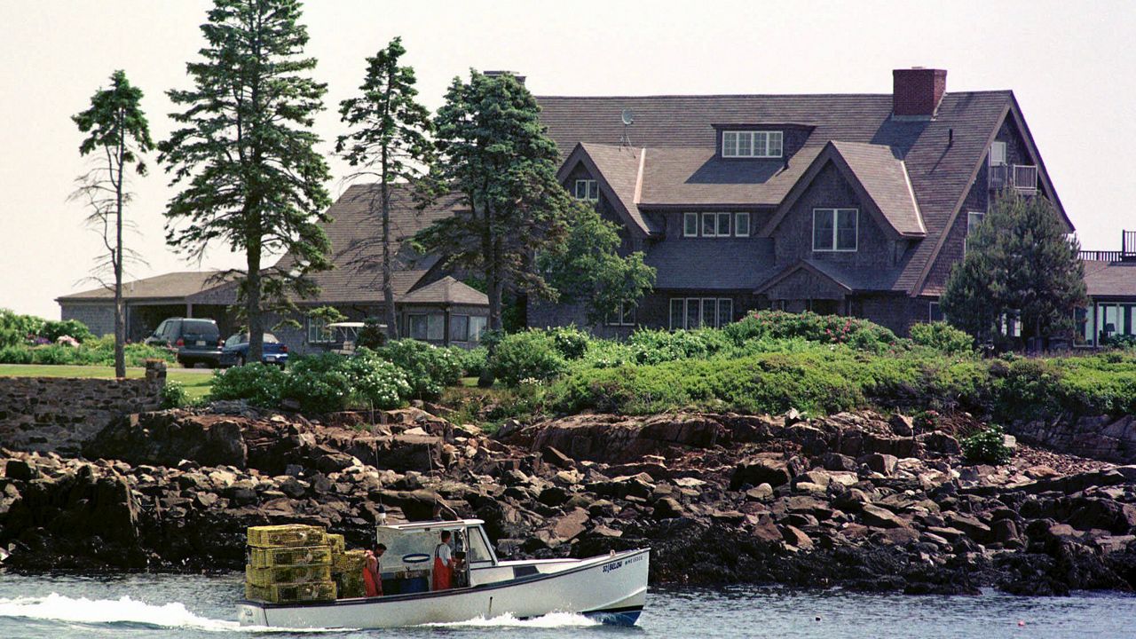  In this June 8, 1999, file photo, a lobster boat works in front of Walker's Point, the seaside home of the Bush family in Kennebunkport. The Coast Guard is searching for a lobsterman who went missing off Walker's Point, it was announced Friday, Nov. 17, 2023. (AP Photo/Robert F. Bukaty, File)