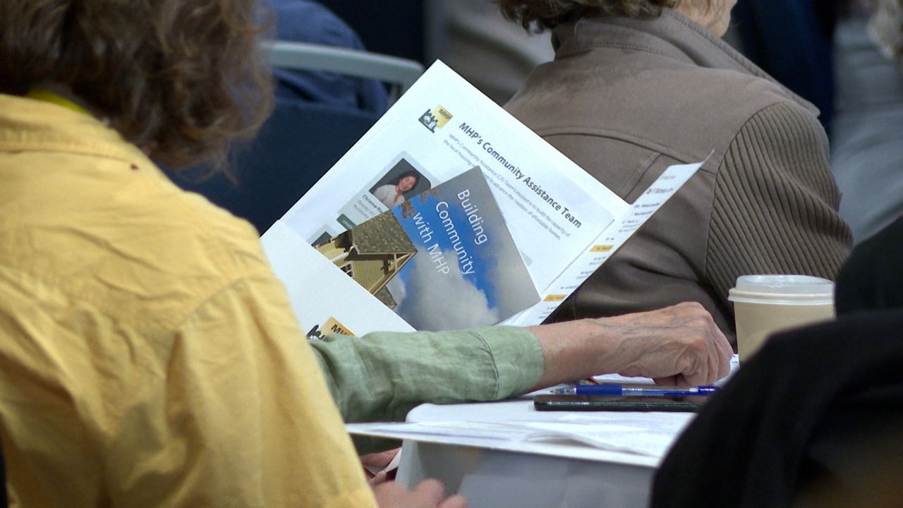 Attendees reading at the MHP Housing Institute. (Spectrum News 1/Dan Reidy)
