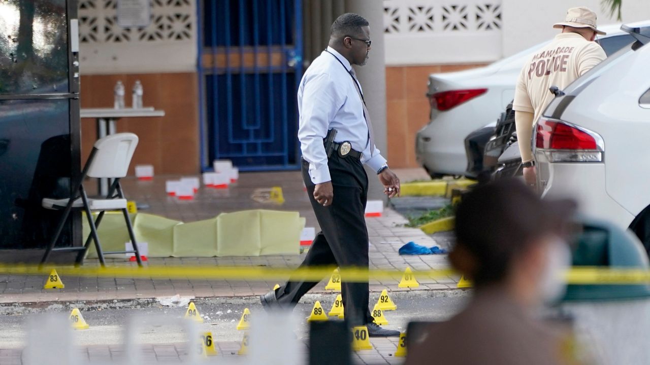 Law enforcement officials work the scene of a shooting outside a banquet hall near Hialeah, Fla., Sunday, May 30, 2021. (AP/Lynne Sladky)