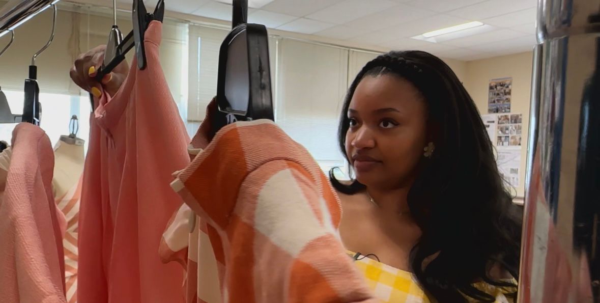 Jewel Moser looking at her designs. (Spectrum News 1/Sydney McCoy)