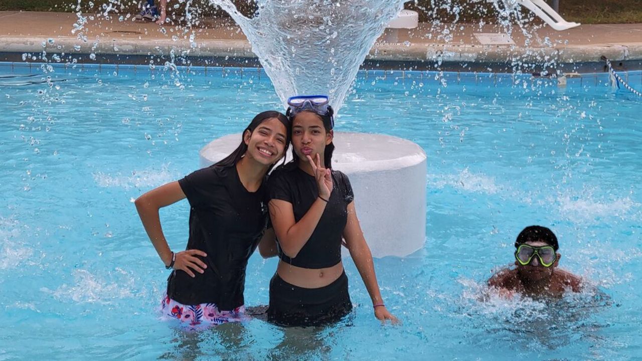 People pose for a photo in the Mabel Davis Pool. (City of Austin)