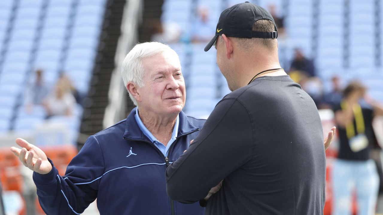 North Carolina Tar Heels head coach Mack Brown, left, and Appalachian State Mountaineers head coach Shawn Clark talk at mid field before an NCAA football game, Saturday, Sept. 9, 2023, in Chapel Hill, N.C. (AP Photo/Reinhold Matay)