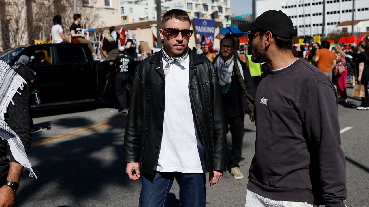 U.S. rapper Macklemore, center, attends a demonstration in support of Palestinians calling for a cease-fire in the Gaza Strip, near the Dolby Theatre where the 96th Academy Awards Oscars ceremony is held, Sunday, March 10, 2024, in the Hollywood section of Los Angeles. (AP Photo/Etienne Laurent, File)