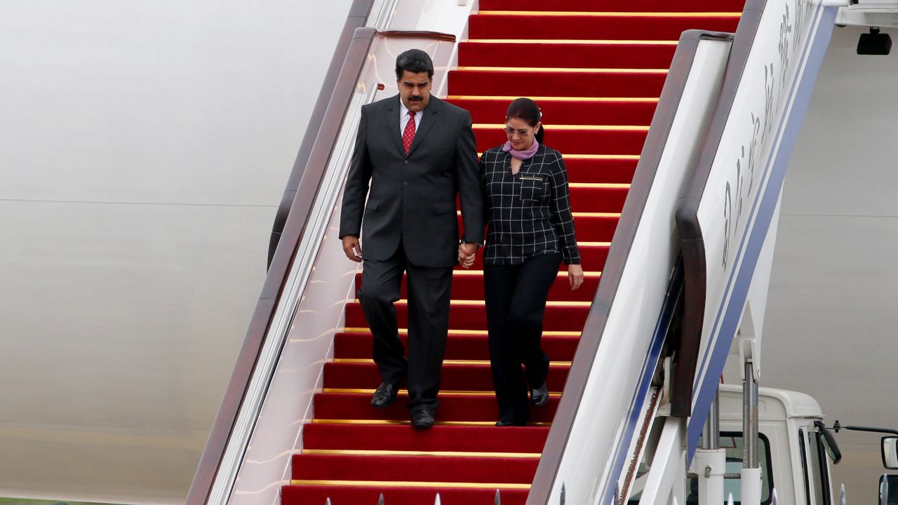 FILE - Venezuela's President Nicolas Maduro, left, and first lady Cilia Flores arrive at Beijing Capital International Airport in Beijing, China, Sept. 1, 2015. (AP Photo/Ng Han Guan, File)