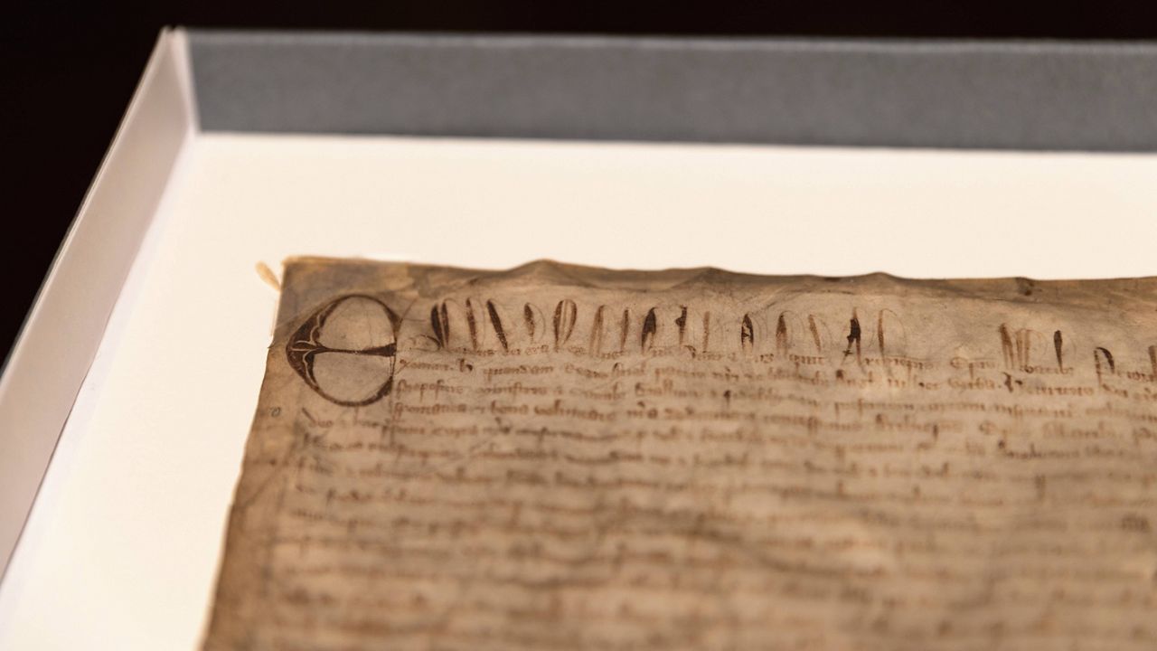 This photo provided by Harvard Law School shows a rare copy of the Magna Carta from 1300 sits in a display case on April 15, 2025, at Harvard Law School in Cambridge, Mass. (Lorin Granger/Harvard Law School via AP)