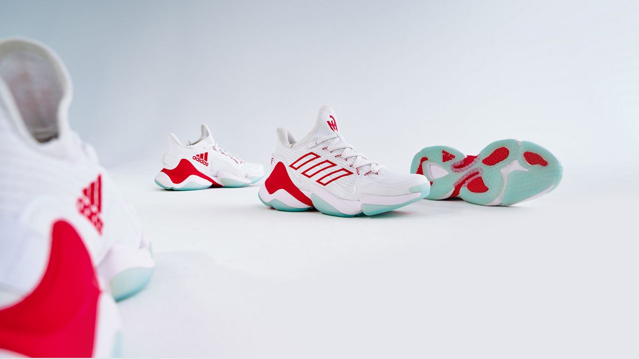 The new adidas shoes are sleek white with bold accents of red, nodding to Kansas City.