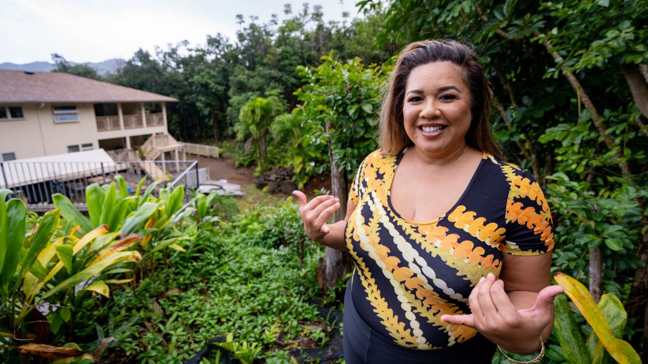 Mailani Makainai, great-great-granddaughter of Hamana Kalili who is known as the father of shaka, flashes a shaka at her home on Wednesday, March 6, 2024, in Kaneohe, Hawaii. (AP Photo/Mengshin Lin)