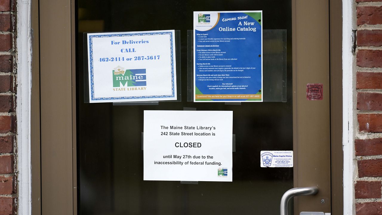 A sign announces the extended closure of the Maine State Library, Wednesday, May 7, 2025, in Augusta, Maine. (AP Photo/Robert F. Bukaty)