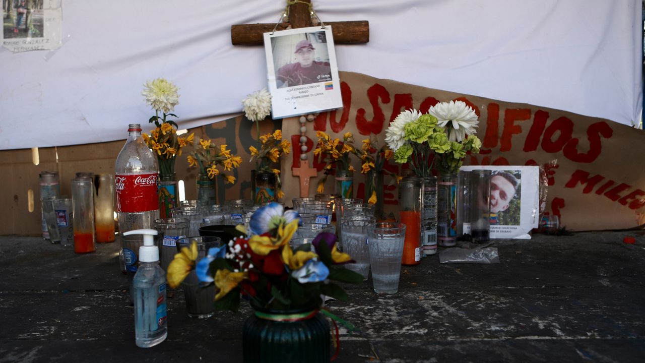 A makeshift altar in honor of migrants who died in last month's fire, sits outside the immigration detention center where a dormitory fire killed more than three dozen people, in Ciudad Juarez, Mexico, Thursday, April 20, 2023. (AP Photo/Christian Chavez)