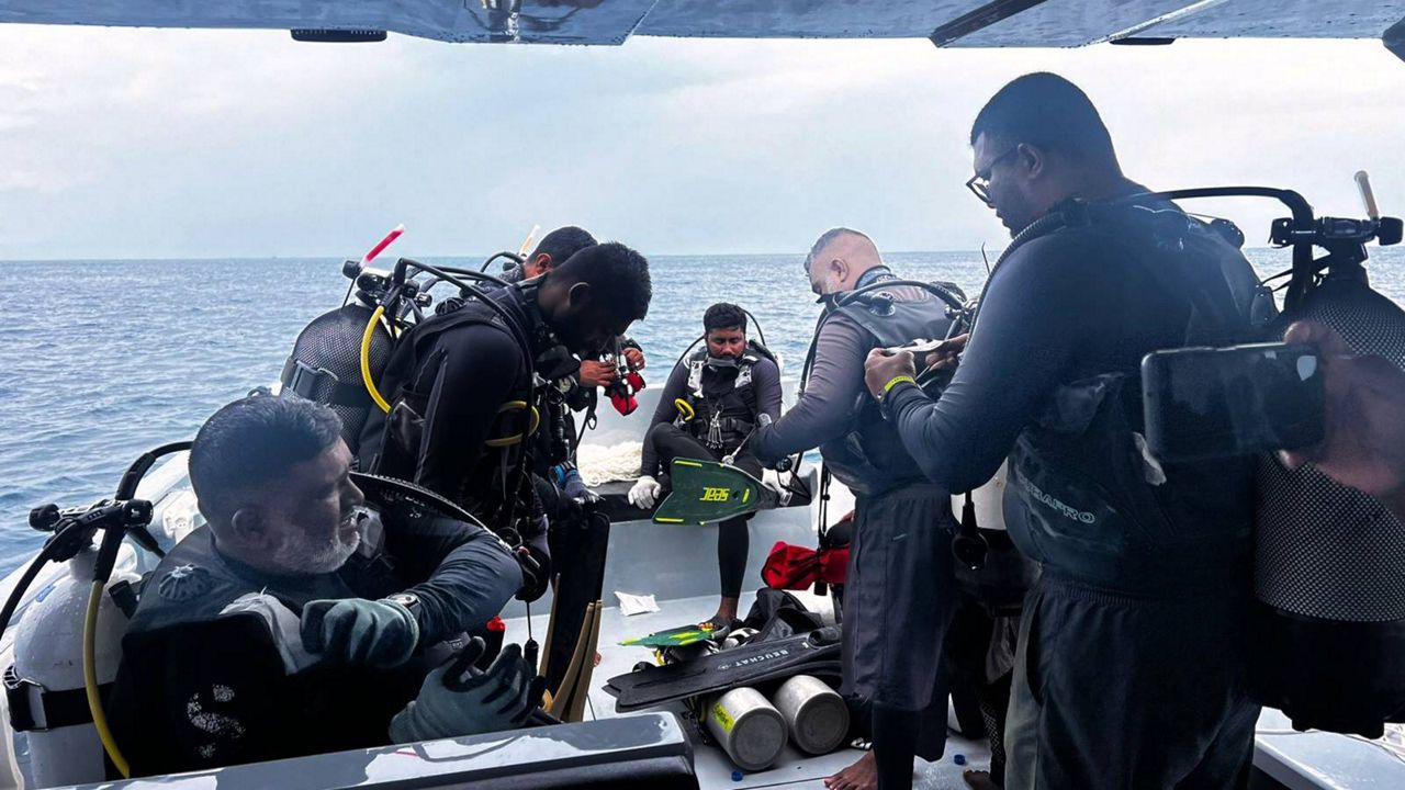 Italy's foreign minister says divers have found bodies of 4 Italians dead in Maldives sea cave