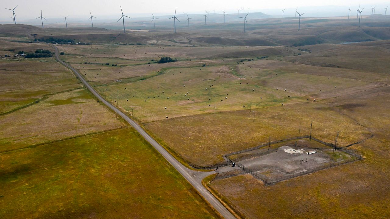 In this image provided by the U.S. Air Force, wind turbines spin near the Malmstrom Air Force Base missile launch site Alpha-03 in Geyser, Mont., in August 2023. (John Turner/U.S. Air Force via AP)