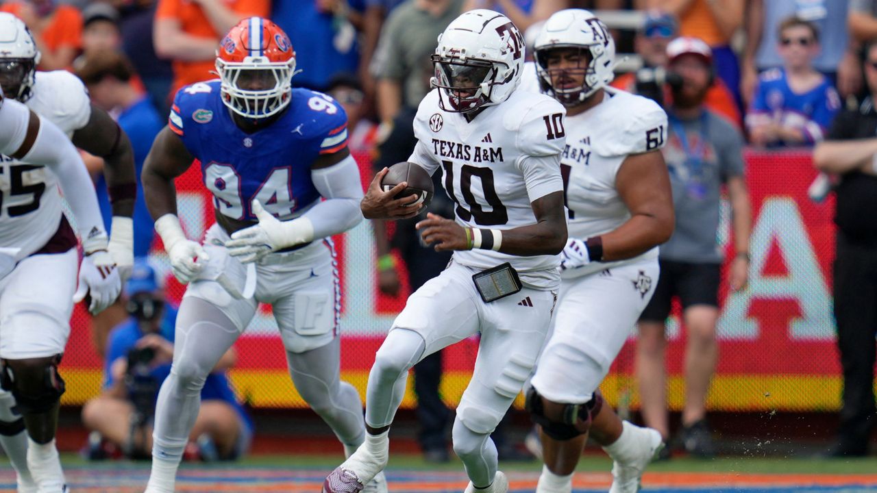 Texas A&M quarterback Marcel Reed (10) scrambles past Florida edge Tyreak Sapp (94) during the first half of an NCAA college football game, Saturday, Sept. 14, 2024, in Gainesville, Fla. (AP Photo/John Raoux)