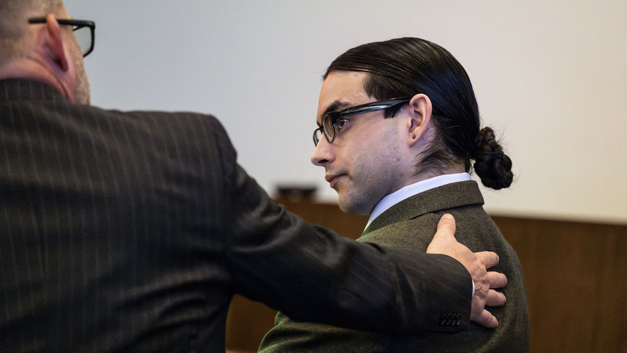 Defendant Marcus Eriz talks with his attorney Randall Bethune before opening statements in his trial, Thursday, Jan. 18, 2024, in Santa Ana, Calif. Eriz, 26, is charged with killing Aiden Leos, 6, while the boy's mother was driving him to kindergarten in Orange County in May 2021. (Paul Bersebach/The Orange County Register via AP)