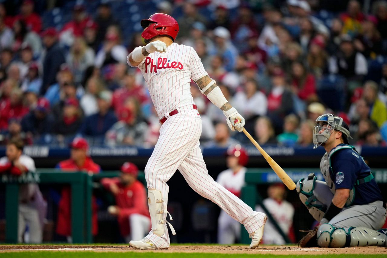 Rhys Hoskins of the Philadelphia Phillies blows a bubble during a in  2023