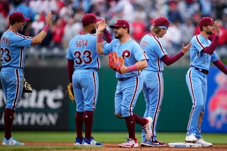 Rhys Hoskins of the Philadelphia Phillies blows a bubble during a in  2023