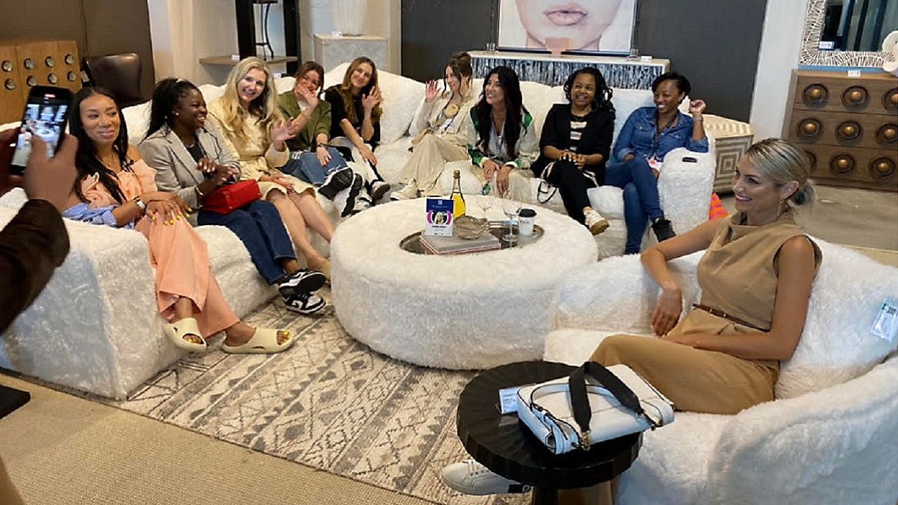Ten design influencers take a photo inside Hooker Furnishings. (Spectrum News 1/Zyneria Byrd)