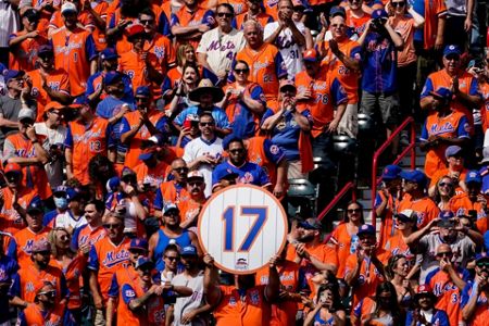 New York Mets announcer and former player Keith Hernandez waves to