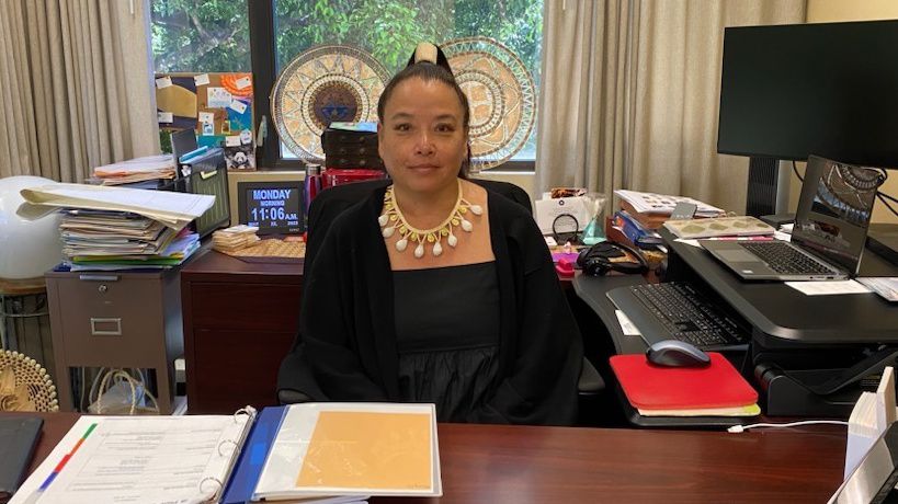 Mary Therese Hattori sits at her desk at the East-West Center while speaking to Spectrum News Hawaii on May 22, 2023. (Spectrum News/Michelle Broder Van Dyke)