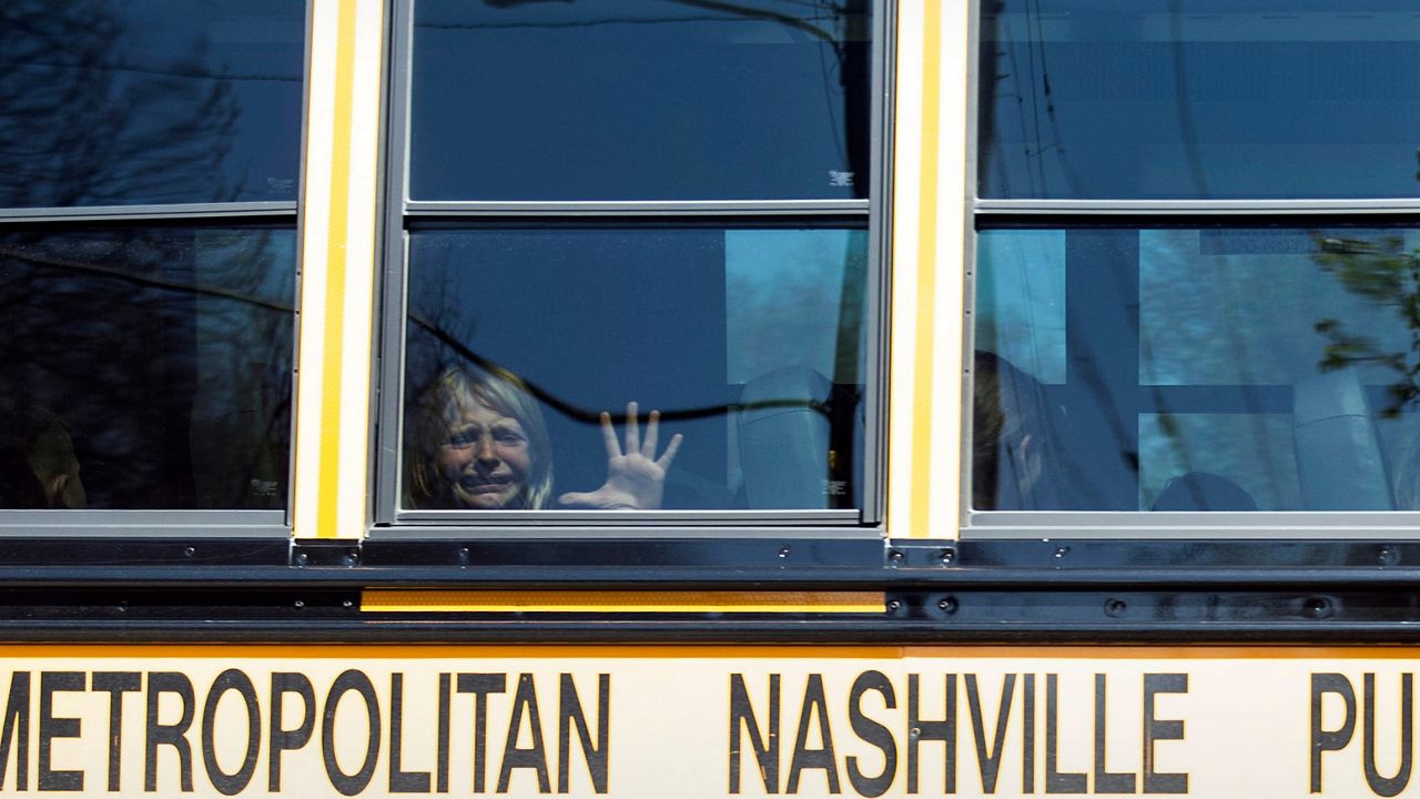 A child weeps while on the bus leaving The Covenant School following a mass shooting at the school in Nashville, Tenn., Monday, March 27, 2023. A 28-year-old killed three children and three adults in a shooting at a small Christian elementary school before being killed by police. The shooter was a former student there. Police have said the shooter “was assigned female at birth” but used masculine pronouns on social media. (Nicole Hester/The Tennessean via AP, File)