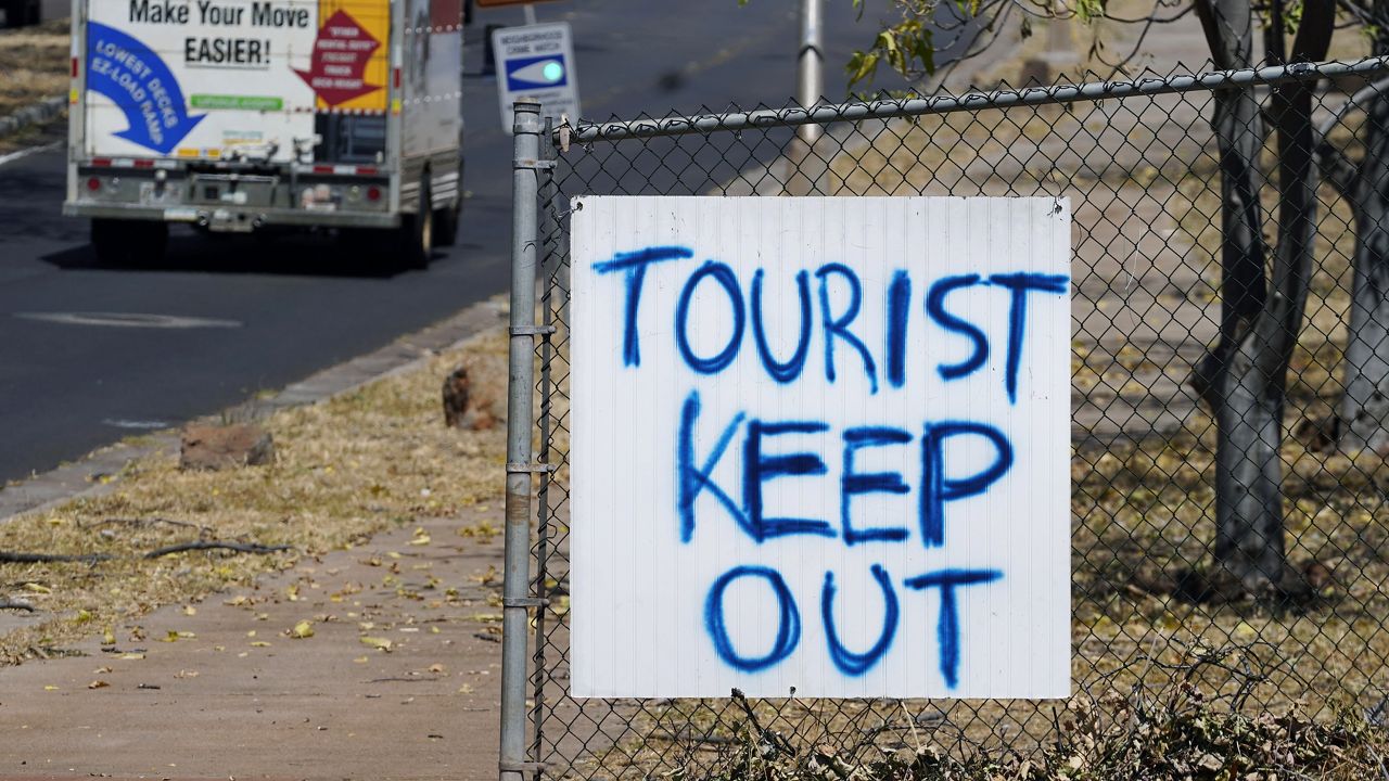A "Tourist Keep Out" sign is displayed in Lahaina following a deadly wildfire that caused damage days earlier. (AP Photo/Rick Bowmer)