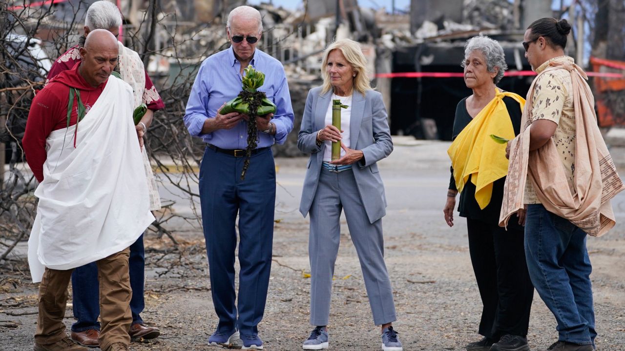 President Joe Biden and first lady Jill Biden participate in a blessing ceremony with the Lahaina elders at Moku'ula as they visit areas devastated by the Maui wildfires, Monday, Aug. 21, 2023, in Lahaina, Hawaii. (AP Photo/Evan Vucci)