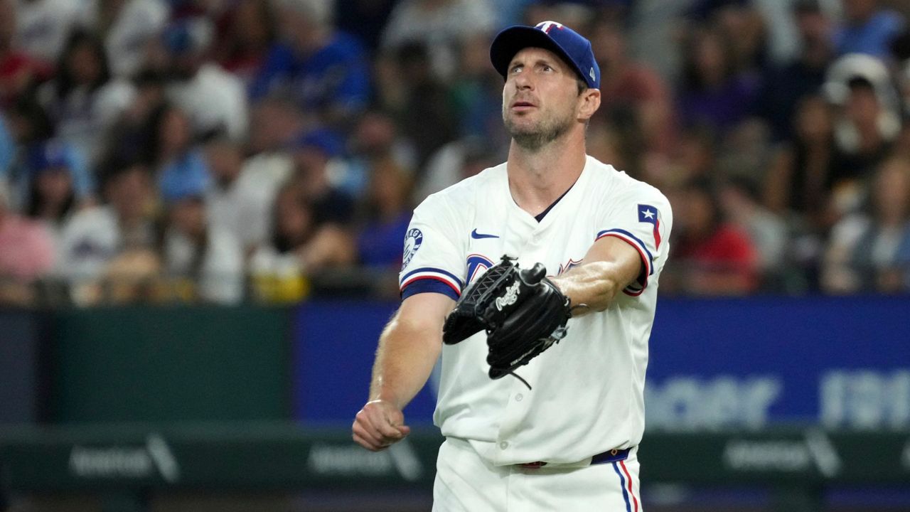 Texas Rangers starting pitcher Max Scherzer reacts after walking Baltimore Orioles' Ryan O'Hearn during the second inning of a baseball game, Saturday, July 20, 2024, in Arlington, Texas. (AP Photo/Jeffrey McWhorter)