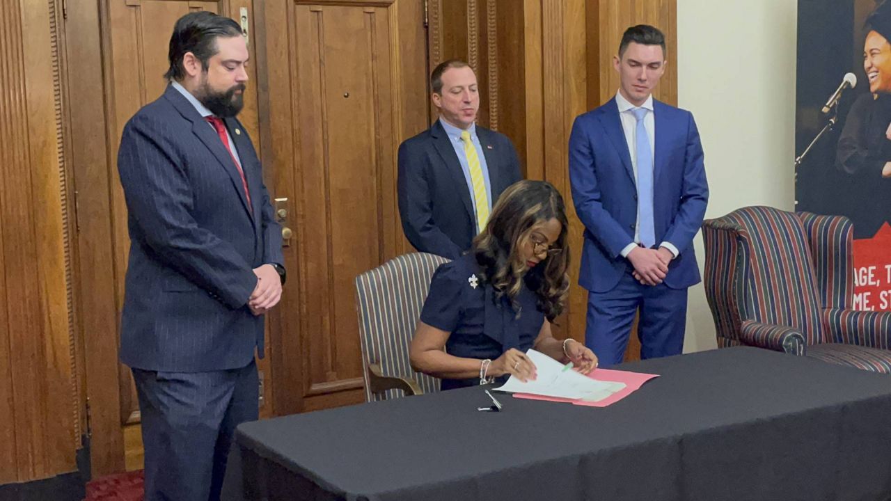 St. Louis Mayor Tishaura Jones signs Board Bills 33 and 34 into law during a ceremony at City Hall Monday. The bills create regulations for the short-term rental housing industry. (Spectrum News/Gregg Palermo)